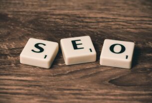 Scrabble tiles spelling 'SEO' on a wooden surface. Ideal for digital marketing themes.